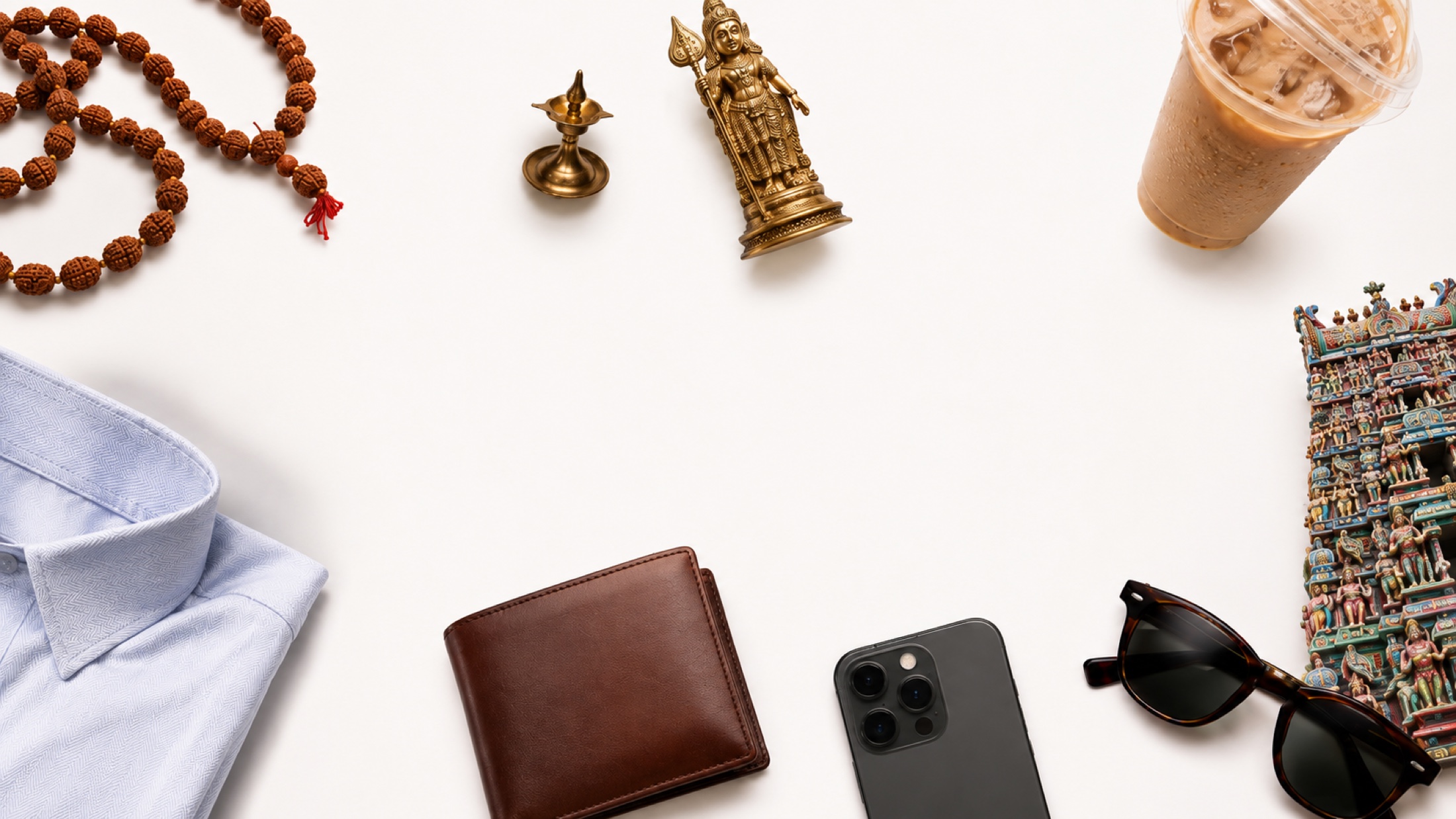 Objects Subramaniam loved and used, including rudraksha beads, a Lord Murugan statue, coffee, a temple, a dress shirt, a wallet, a phone, glasses, and a lamp
